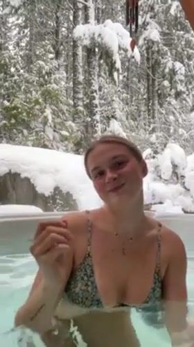 Woman enjoys hot tub amid heavy snow in Whistler