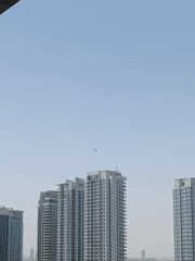 Helicopter spotted over Dubai cityscape and parking areas