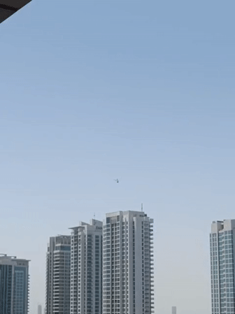 Helicopter spotted over Dubai cityscape and parking areas