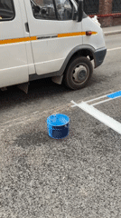 Road workers paint blue street markings in Moscow