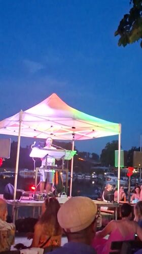 Live band plays under glowing tent at dusk in Wiesbaden