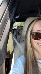 Woman takes car selfie with child in Moscow