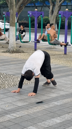 Man performs early morning stretching routine in Jiangjin park