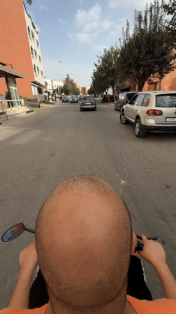 Man rides black scooter through Safi streets