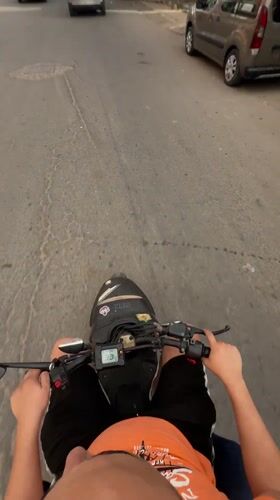Man rides black scooter through Safi streets