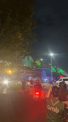 Nighttime dancing and dragon bridge spectacle captured in urban setting