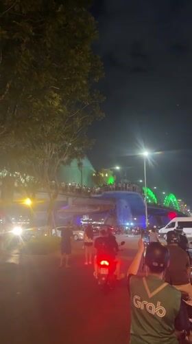 Nighttime dancing and dragon bridge spectacle captured in urban setting