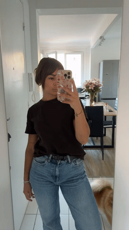 Woman takes selfies in Cannes hallway during afternoon