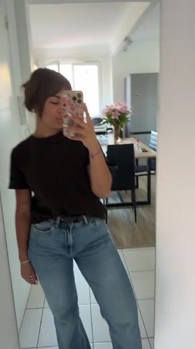 Woman takes selfies in Cannes hallway during afternoon