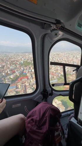 Helicopter flies over Kageshwori Manohara, Nepal in clear weather
