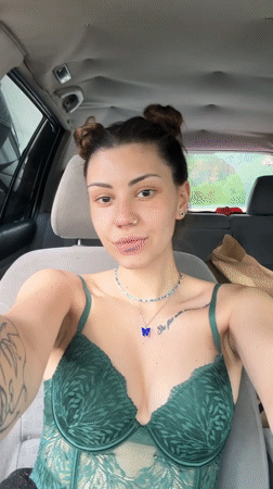 Woman takes selfies in car in Bulgarian village