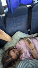 Three women travel together on bus, two resting