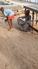 Children doing chores outdoors in Nigerian village