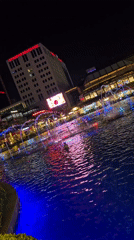 Illuminated fountain and selfie-taking ape statue documented in Ataşehir