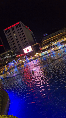 Illuminated fountain and selfie-taking ape statue documented in Ataşehir