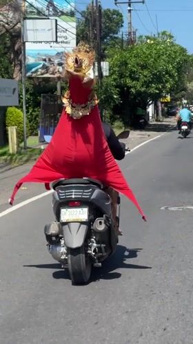 Ceremonial dress on a scooter, cafe life in Denpasar