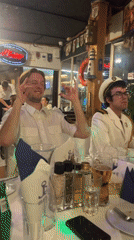 Nautical-uniformed group dines at themed restaurant in Budva