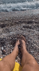 Beachgoer relaxes on sunny Kamenovo pebble beach, Montenegro
