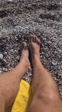 Beachgoer relaxes on sunny Kamenovo pebble beach, Montenegro