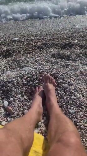 Beachgoer relaxes on sunny Kamenovo pebble beach, Montenegro
