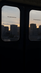 Train passenger views Moscow cityscape at sunset