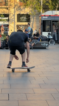 Skateboarders gather in Barcelona plaza during sunny evening session