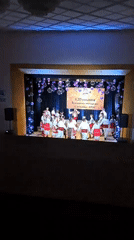 Folk dance celebration documented with traditional costumes and decorations