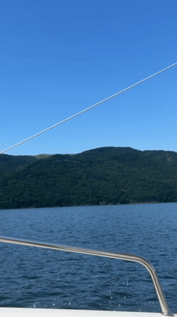 Boat ride on calm Bulgarian waters beneath a clear summer sky
