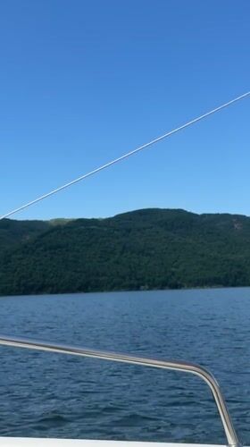 Boat ride on calm Bulgarian waters beneath a clear summer sky