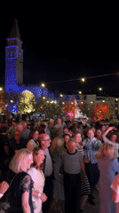 Nighttime festival celebration in Piran's historic plaza