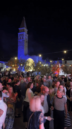 Nighttime festival celebration in Piran's historic plaza