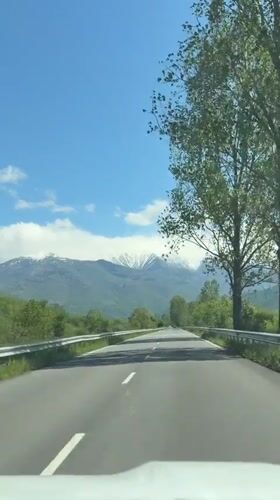 Morning highway drive captured near snow-capped mountains in Bulgaria