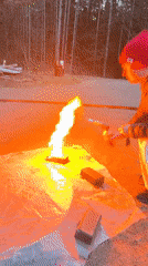 Man operates gas torch near rural road in Прикамский