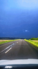 Evening drive ends at a lakeside campfire under a stormy sky