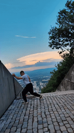 Man performs backflip on elevated stone surface in Shumen