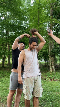 Late-night outdoor haircut session in Washington Township woods