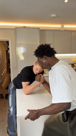 London friends arm wrestle, share victory messages digitally