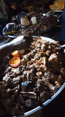 Vendors serve grilled meat platters at outdoor food stand