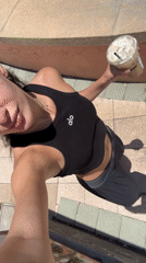 Woman in activewear takes selfies near Boca Raton pavilion