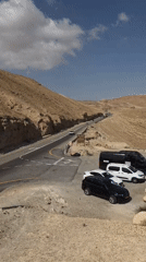 Morning traffic flows through Tamar desert highway near Masada