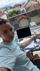 Woman works from balcony home office in Tivat