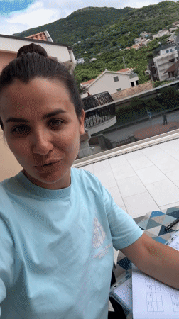 Woman works from balcony home office in Tivat