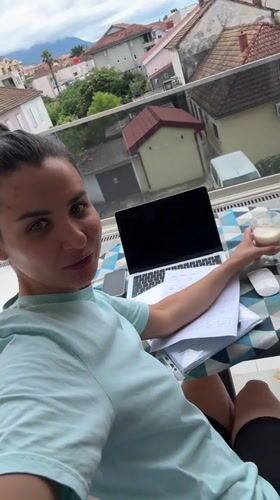 Woman works from balcony home office in Tivat