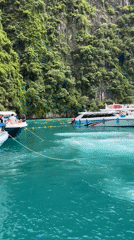 Longtail and speedboats navigate Ao Nang's karst-lined waters