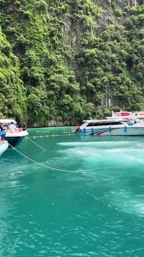 Longtail and speedboats navigate Ao Nang's karst-lined waters