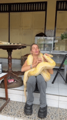 Woman handles exotic animals, tourists visit Bali water palace