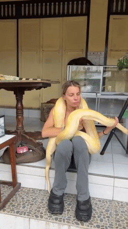 Woman handles exotic animals, tourists visit Bali water palace