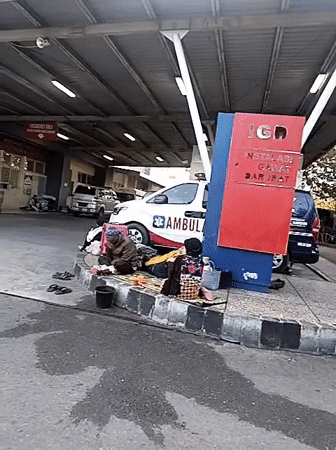 People gather outside RSUDZA hospital emergency department in Banda Aceh
