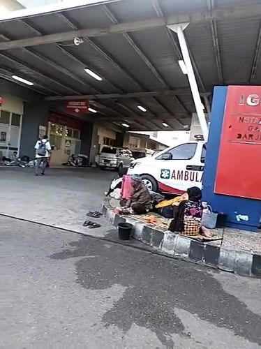 People gather outside RSUDZA hospital emergency department in Banda Aceh