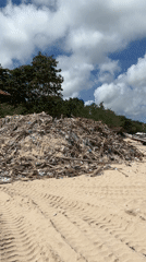Beach pollution documented in Kuta, Indonesia with debris piles